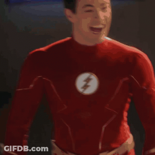 A Man In A Red Superhero Costume Is Standing In Front Of A Display Of A Man In A Red Suit GIF