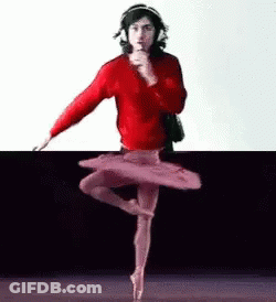 A Man In A Red Sweater Is Dancing In A Tutu While Wearing Headphones . GIF