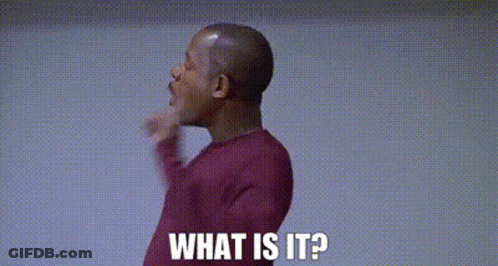 A Man In A Red Sweater Is Giving A Thumbs Up And Says `` What Is It ? '' GIF