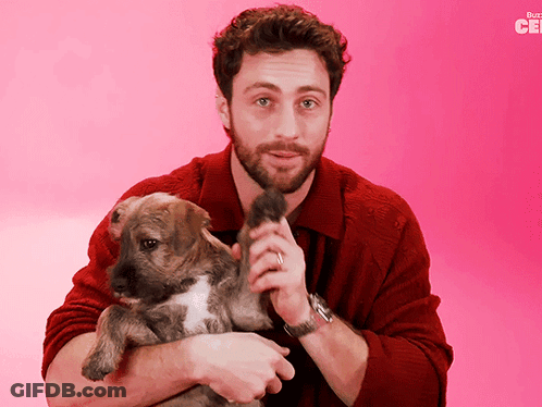 Man In Red Sweater Holding Puppy Buzzfeed Logo GIF