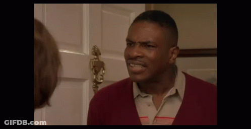 A Man In A Red Sweater Is Making A Funny Face GIF