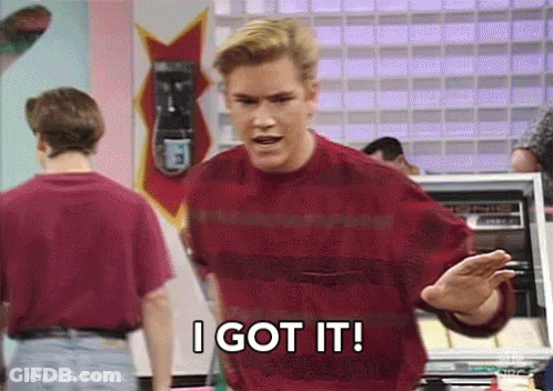 A Man In A Red Sweater Is Saying `` I Got It '' While Standing In Front Of A Machine . GIF