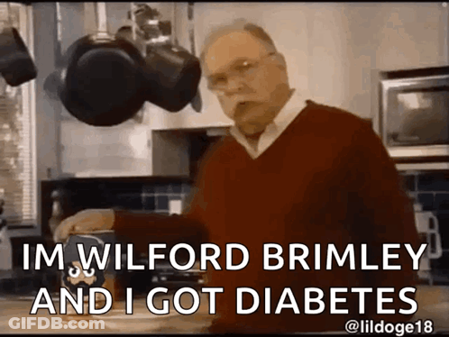 A Man In A Red Sweater Is Standing In A Kitchen And Says " Im Wilford Brimley And I Got Diabetes " . GIF