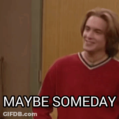 A Man In A Red Sweater Is Standing In Front Of A Door And Smiling . GIF
