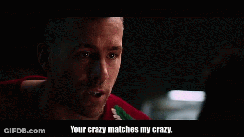 A Man In A Red Sweater Is Talking To Another Man In A Dark Room And Says `` Your Crazy Matches My Crazy '' . GIF