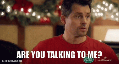 A Man In A Red Sweater Is Talking To Another Man In A Hallmark Christmas Movie . GIF
