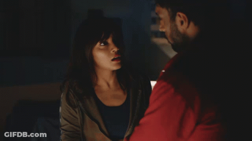 A Man In A Red Sweatshirt Sits At A Desk With A Woman GIF