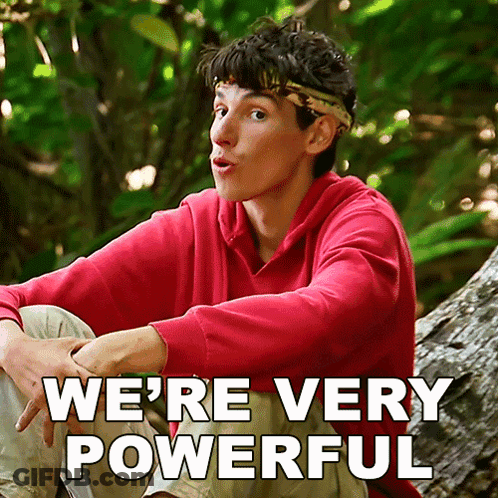 A Man In A Red Sweatshirt Sits On A Tree Trunk With The Words " We 'Re Very Powerful " Written Below Him GIF