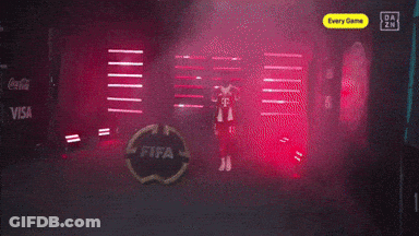 A Man In A Red T-Mobile Jersey Stands In A Dark Room GIF
