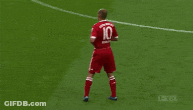 A Man In A Red T-Mobile Jersey Stands In Front Of A Crowd GIF