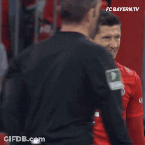 A Man In A Red T-Mobile Jersey Stands In Front Of A Goal GIF