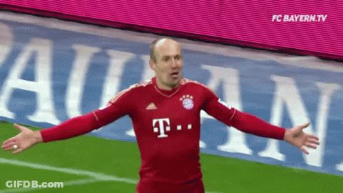 A Man In A Red T-Mobile Jersey Stands On A Field With His Arms Outstretched GIF