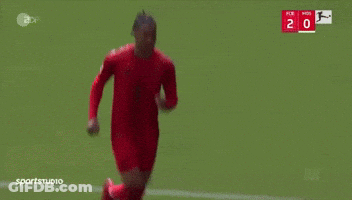 A Man In A Red T-Mobile Shirt Is Covering His Ears During A Soccer Game GIF