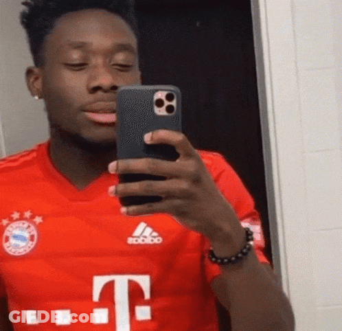 A Man In A Red T-Mobile Shirt Takes A Selfie With His Phone GIF