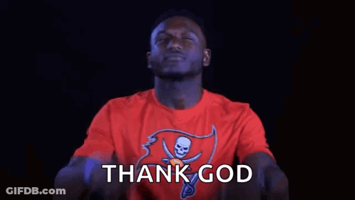 A Man In A Red T-Shirt Is Pointing Up With His Fingers And Saying Thank God . GIF