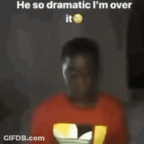 A Man In A Red T-Shirt Is Standing In Front Of A Television . GIF