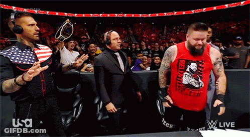 A Man In A Red Tank Top With The Word Revolution On It Stands In Front Of A Crowd GIF