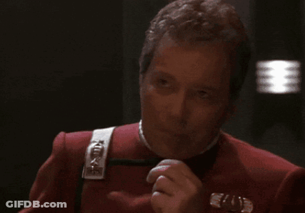 A Man In A Red Uniform Is Covering His Mouth GIF