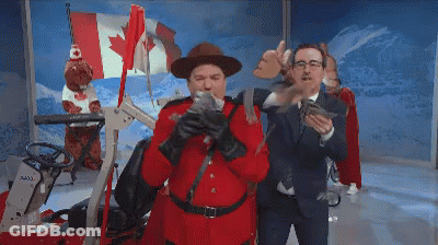 A Man In A Red Uniform Is Holding A Gun GIF