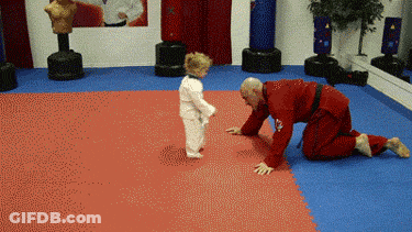 A Man In A Red Uniform Is Kneeling Down Next To A Little Boy GIF