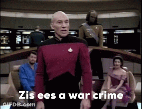A Man In A Red Uniform Stands In Front Of A Group Of People And Says Zis Ees A War Crime . GIF