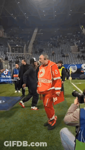 A Man In A Red Uniform With The Number 13 On It Walks On A Soccer Field GIF