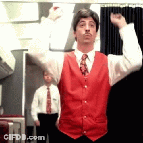 A Man In A Red Vest And Tie Is Raising His Arms In The Air GIF