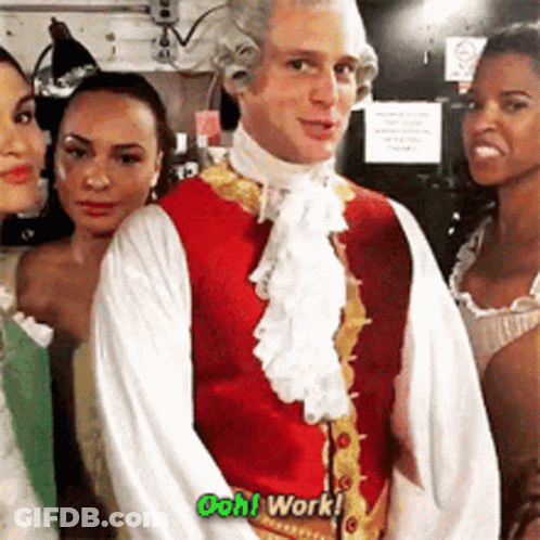 A Man In A Red Vest And White Shirt Is Standing In Front Of Three Women And Says Ooh Work GIF