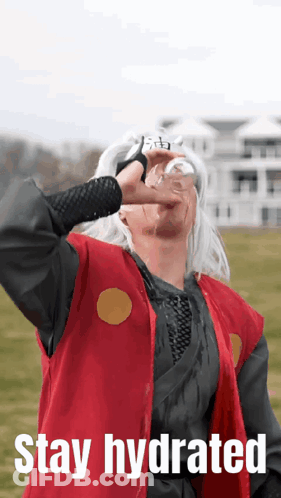 A Man In A Red Vest Is Drinking From A Glass With The Words Stay Hydrated Above Him GIF