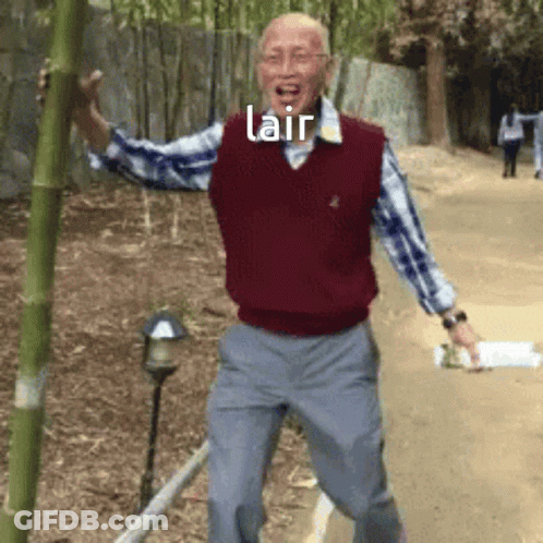 A Man In A Red Vest Is Holding A Bamboo Pole With The Word Lair Above Him GIF