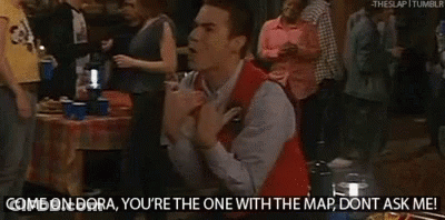 A Man In A Red Vest Is Kneeling In Front Of A Crowd And Says Come On Dora You 'Re The One With The Map GIF