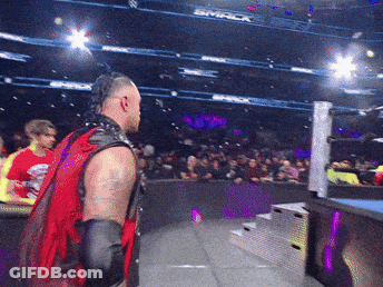 A Man In A Red Vest Stands In Front Of A Crowd At A Smack Wrestling Event GIF