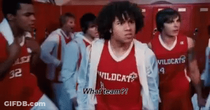 A Man In A Red Wildcats Jersey Is Standing In A Locker Room GIF