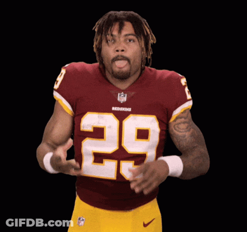 A Man In A Redskins Jersey With The Number 29 On His Chest GIF