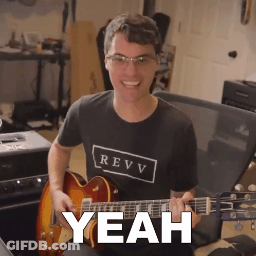 A Man In A Revv Shirt Is Playing A Guitar And Says Yeah GIF