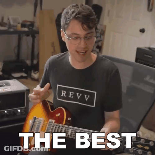 A Man In A Revv Shirt Playing A Guitar GIF