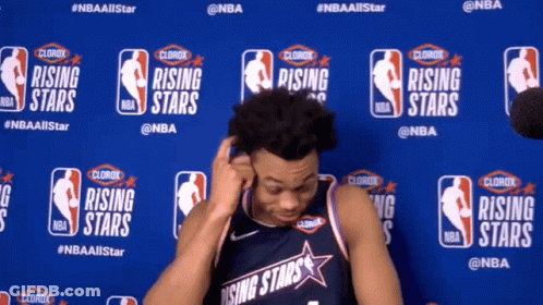 A Man In A Rising Stars Jersey Is Standing In Front Of A Blue Wall GIF