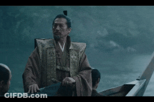 A Man In A Robe Is Standing In A Boat GIF