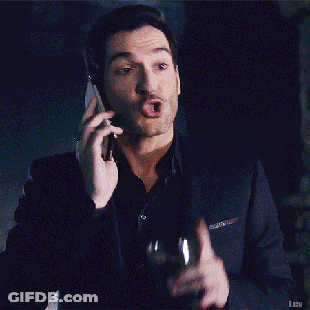 A Man In A Robe Is Standing In Front Of A Window And Waving . GIF