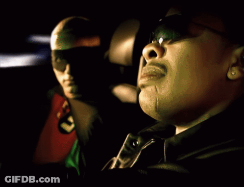 A Man In A Robin Costume Sits Next To Another Man In A Black Jacket GIF