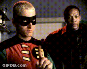 A Man In A Robin Costume With The Letter B On It GIF