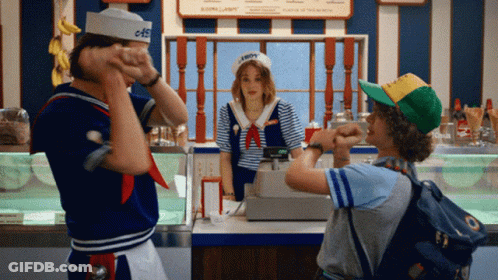 A Man In A Sailor Hat Stands In Front Of A Woman In A Sailor Costume GIF