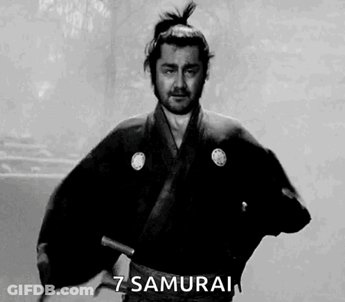 A Man In A Samurai Costume Is Holding A Sword In His Hand . GIF