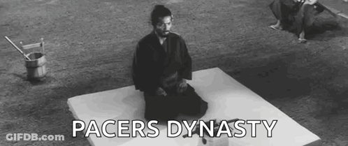 A Man In A Samurai Costume Is Kneeling On A Mat . GIF