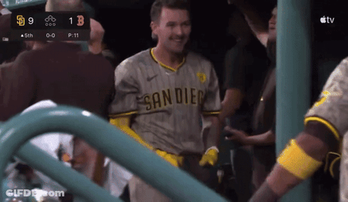 A Man In A San Diego Jersey Stands In Front Of A Scoreboard GIF