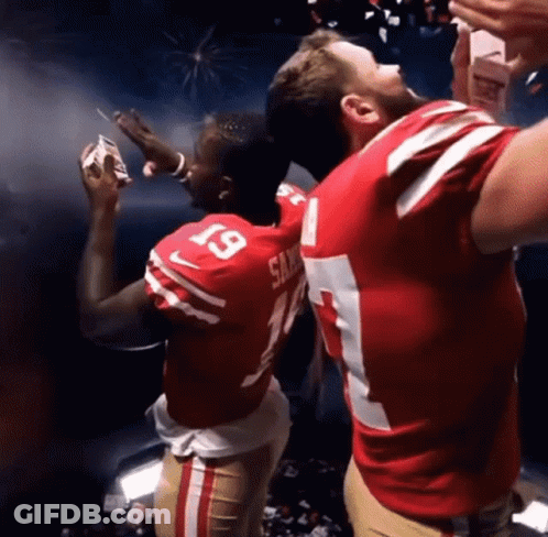 A Man In A San Francisco 49Ers Jersey Is Holding A Cigarette GIF