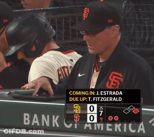 A Man In A San Francisco Giants Baseball Uniform Is Standing In The Dugout GIF