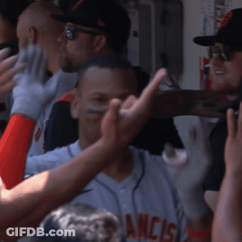 A Man In A San Francisco Jersey Is Being High Fived By His Teammates GIF