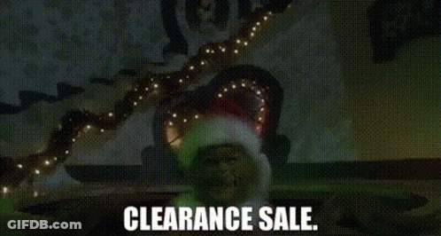 A Man In A Santa Hat Is Standing In Front Of A Christmas Tree With Lights . GIF