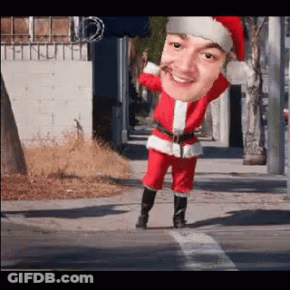 A Man In A Santa Suit Is Crossing The Street GIF